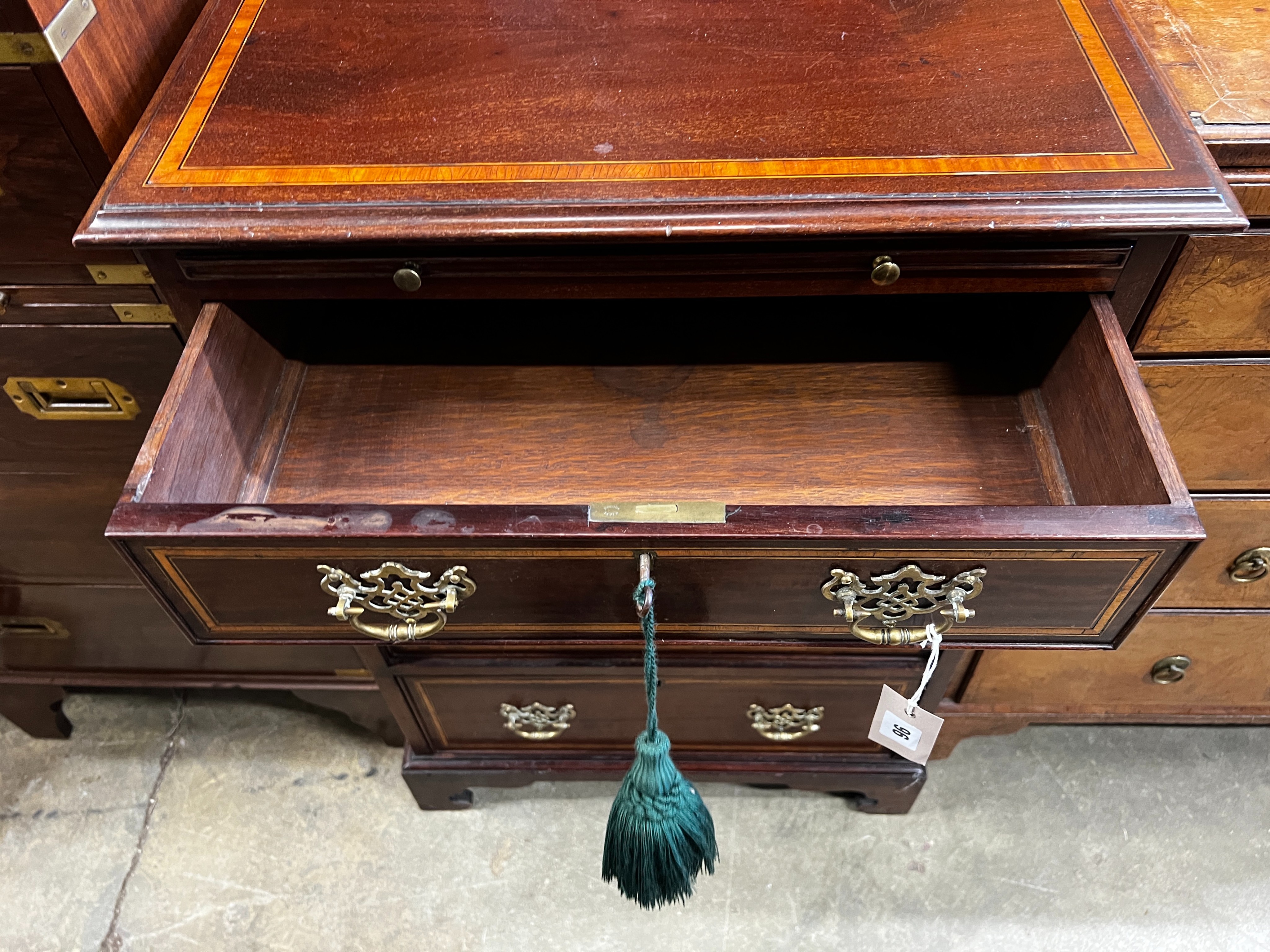 A small George III style satinwood banded mahogany four drawer chest fitted slide, width 56cm, depth 48cm, height 82cm